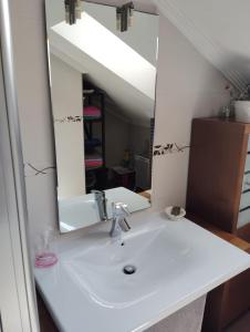 a bathroom with a sink and a mirror at La Casina Azul de May in San Juan de la Arena +14 photos