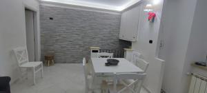 a white dining room with a white table and chairs at Il Fiordaliso in Anagni +9 photos