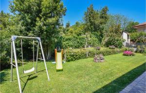 a yard with a swing set in the grass at Amazing Apartment In Trecastagni in Trecastagni