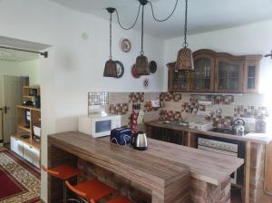 a kitchen with a wooden table in a room at Bambusz ház in Rábapaty