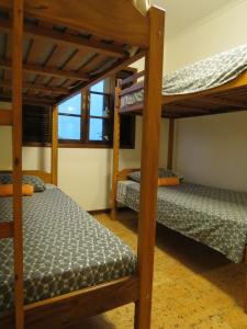 a bedroom with two bunk beds and a window at Bertioga Beach Hostel in Bertioga +28 photos