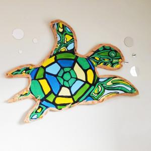 a stained glass turtle cookie on a white surface at Paradise Beach Oasis in Indialantic