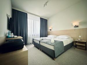 Posteľ alebo postele v izbe v ubytovaní Hotel Turkus