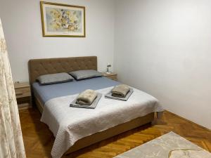 a bedroom with a bed with two pillows on it at Apartment Luka in Ljubuški