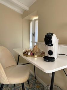 a table with a coffee maker and cookies on it at Fiasella 21 in Sarzana