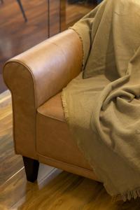 a brown couch with a blanket on top of it at Turnberry accommodation in Turnberry