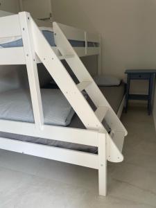 a white bunk bed in a room with a table at Apartment De Frata in Frata