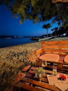 a table with wine glasses on the beach at Villa Nada - room for 2 in Duće +4 photos