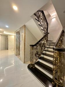a staircase with black and gold railings in a house at Motel Victoria in Ho Chi Minh City +24 photos