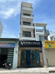 a man standing in front of a building at Motel Victoria in Ho Chi Minh City