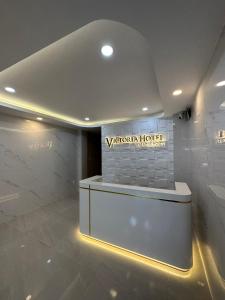 a lobby of a hotel with a sign on the wall at Motel Victoria in Ho Chi Minh City