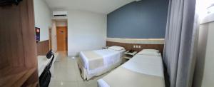 Postel nebo postele na pokoji v ubytování Hotel Gamboa Premium Macau