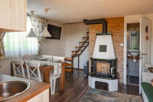 a kitchen and living room with a wood stove at Kuća za odmor Vida in Čazma