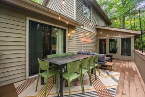 a screened in porch with a table and chairs at Game Room Hot Tub Mins to Slopes Fire Pit in McGaheysville