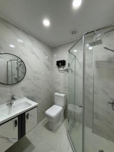 a bathroom with a shower and a toilet and a sink at Dreamside Apartment in Chakvi +7 photos