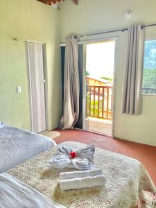 a bedroom with a bed with a towel on it at Pousada Ondas do Vento in Tatajuba