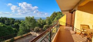a balcony of a building with a view of trees at Bellalisa Tuscany Appartement in Sarteano