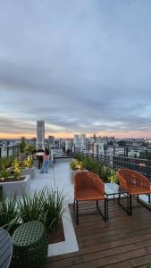 a balcony with chairs and a view of a city at Studio Novo Alto Padrão - Centro in Curitiba