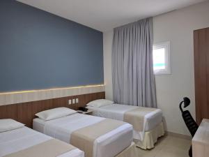 Postel nebo postele na pokoji v ubytování Hotel Gamboa Premium Macau