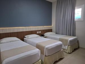 Postel nebo postele na pokoji v ubytování Hotel Gamboa Premium Macau