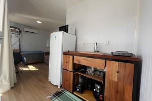 a kitchen with a white refrigerator and a sink at LN Studios in Uberlândia