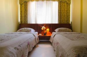A bed or beds in a room at Hotel Bojatours