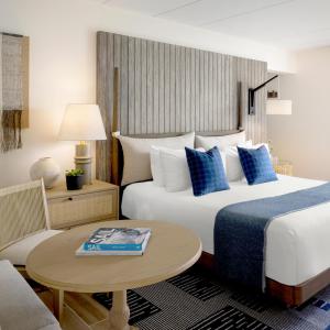 a hotel room with a bed and a table at Newport Harbor Island Resort in Newport
