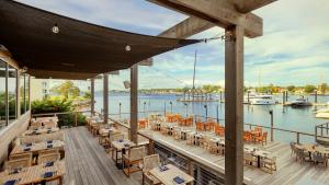 a restaurant with tables and chairs on a deck at Newport Harbor Island Resort in Newport