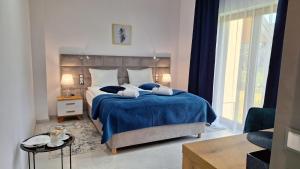 A bed or beds in a room at ELFF -Apartamenty i pokoje gościnne