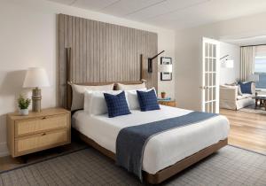 a bedroom with a large bed with blue pillows at Newport Harbor Island Resort in Newport