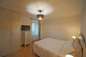 a bedroom with a bed and a television in it at La Corte di GreSi in Tivoli