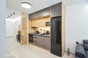 a kitchen with a black refrigerator in a room at New Luxury Apartment near Center with Garden View in Bendevís