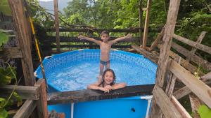 a boy and a girl in a swimming pool at Neyla Suit in Arhavi