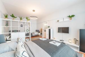a bedroom with a large bed and a tv at City Apartment near Aupark in Košice