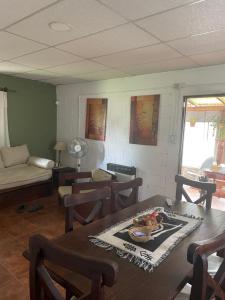 a living room with a table and chairs and a couch at Cabañas KAPO TEAM in Villa Amancay