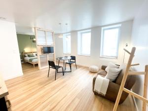 a living room with a couch and a table at Le petit loft in Brest