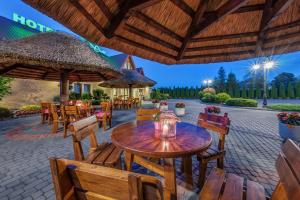 an outdoor patio with tables and chairs and umbrellas at Leśny Dwór in Radom