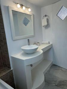 a white bathroom with a sink and a mirror at Marielen House in Kampos Paros +14 photos