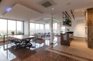 a dining room and living room with a table and chairs at Brand New Loft Near Paseo La Galeria in Asuncion