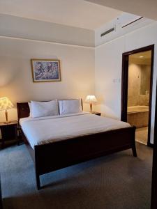 a bedroom with a large bed and a bathroom at Best Apartment Suite At Times Square KL in Kuala Lumpur +17 photos