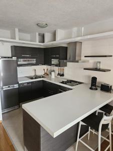 a large kitchen with a white counter top and appliances at Klara in Vodice