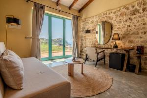 a living room with a couch and a mirror at Kalesma Himare in Himare +86 photos