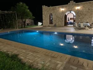 a swimming pool in front of a house at night at Gîte avec piscine privé in Agadir