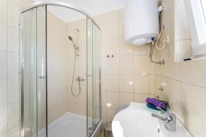 a bathroom with a shower and a toilet and a sink at Apartments Crnko, 50m from the beach with free parking and drinkable tap water in Vir +136 photos