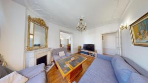 a living room with a couch and a fireplace at Appartement Familial - Saint-Lazare à moins de 15 min in Bois-Colombes