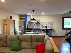 a living room with a couch and a kitchen at Cal Palaci in Caserras