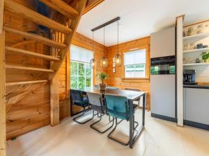 a dining room with a table and chairs at Holiday Home by Zuidlaardermeer with Jetty in Groningen