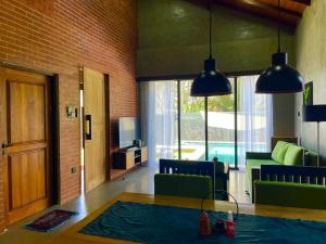a living room with green chairs and a table at Negombo Morawala Beach Villa in Negombo