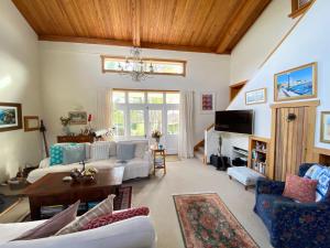 a living room with a couch and a table at The Woolshed Estate at Tata Beach in Tata Beach