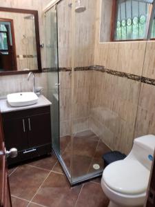 a bathroom with a shower and a toilet and a sink at Casa Pinilla in Ricaurte